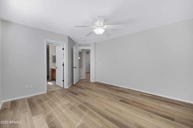 unfurnished bedroom featuring ceiling fan, visible vents, baseboards, light wood-style floors, and ensuite bathroom