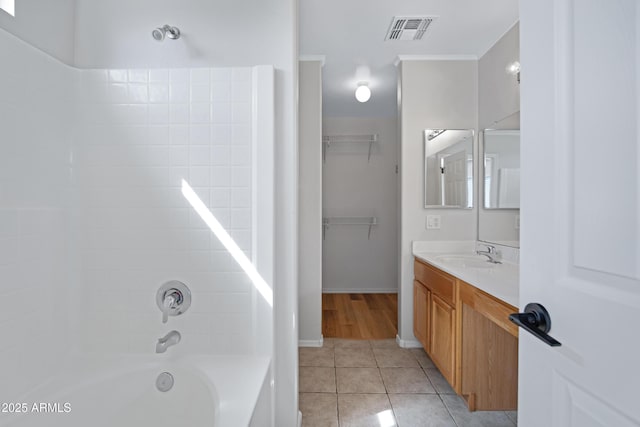 full bath featuring tile patterned flooring, vanity, shower / bathing tub combination, visible vents, and ornamental molding