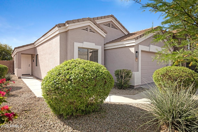 view of property exterior with a garage and stucco siding
