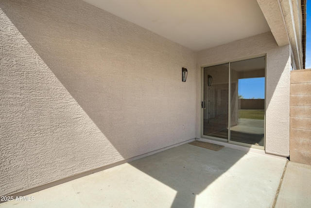 property entrance featuring a patio area and stucco siding