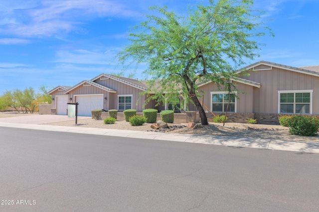 1336 E Belmont Ave, Phoenix, AZ 85020 - single story home featuring board and batten siding, a garage, concrete driveway, and brick siding