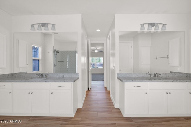 1336 E Belmont Ave, Phoenix, AZ 85020 - full bath with a shower stall, two vanities, recessed lighting, and wood finished floors