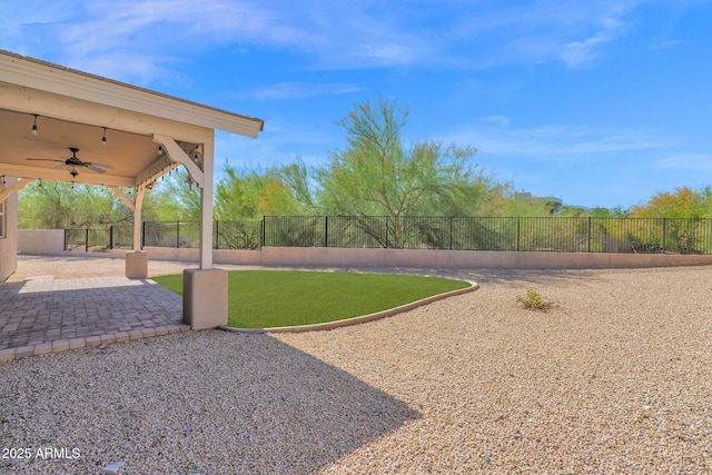 1336 E Belmont Ave, Phoenix, AZ 85020 - fenced backyard with ceiling fan and a patio area