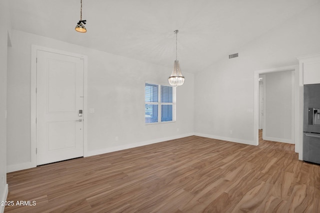 1336 E Belmont Ave, Phoenix, AZ 85020 - unfurnished dining area featuring light wood finished floors, vaulted ceiling, and a chandelier