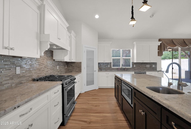 1336 E Belmont Ave, Phoenix, AZ 85020 - kitchen featuring stainless steel appliances, premium range hood, white cabinets, light wood-type flooring, and recessed lighting