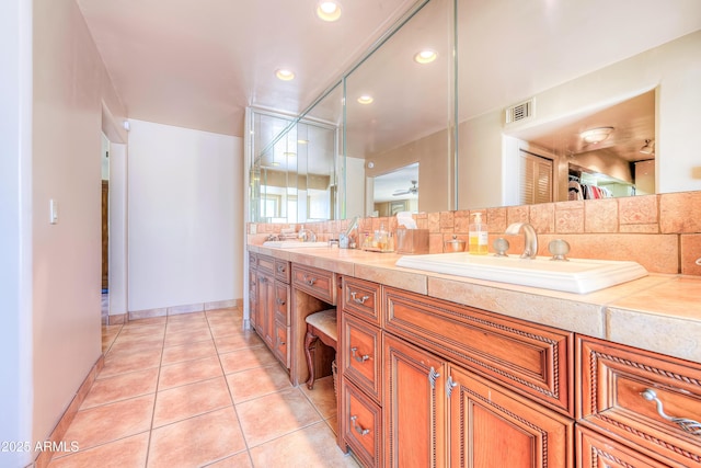 7155 E Oakmont Dr, Paradise Valley, AZ 85253 - bathroom featuring decorative backsplash, visible vents, a sink, tile patterned floors, and double vanity