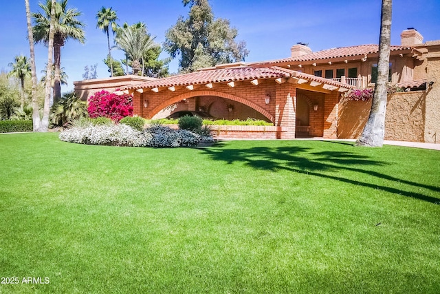 7155 E Oakmont Dr, Paradise Valley, AZ 85253 - back of house featuring a tiled roof, a chimney, and a lawn