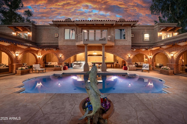 7155 E Oakmont Dr, Paradise Valley, AZ 85253 - pool at dusk with a patio area, an outdoor living space, and an outdoor pool