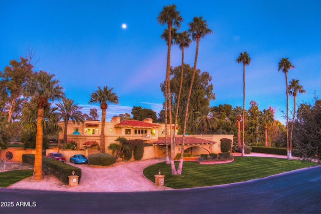 7155 E Oakmont Dr, Paradise Valley, AZ 85253 - view of front of home featuring curved driveway, a tile roof, a front lawn, an attached garage, and a chimney