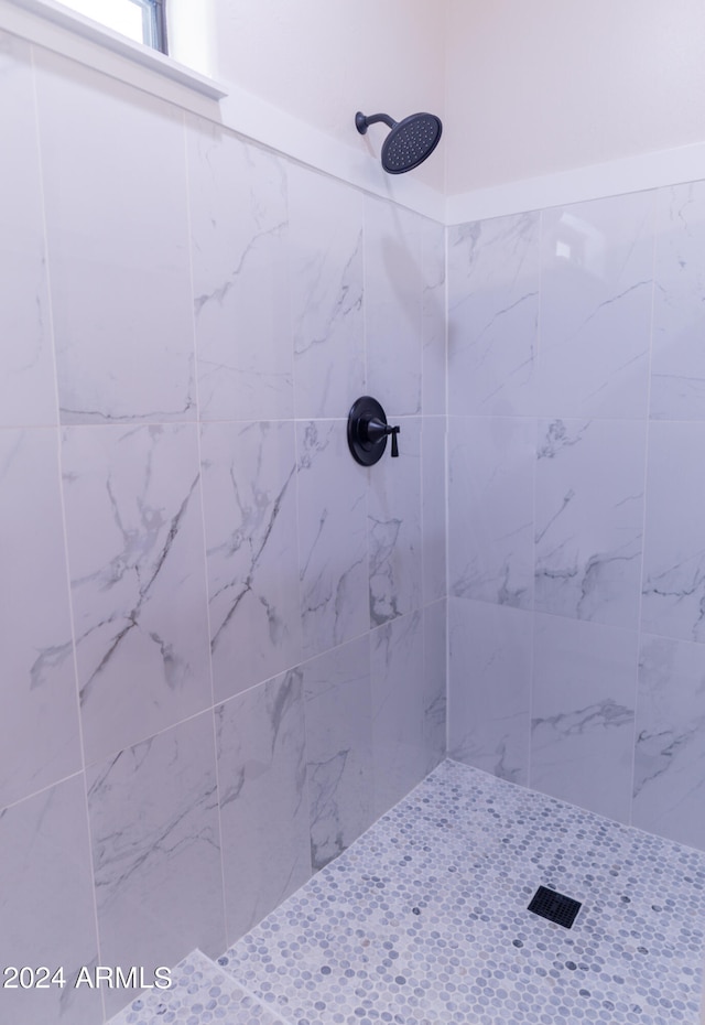 bathroom with a tile shower