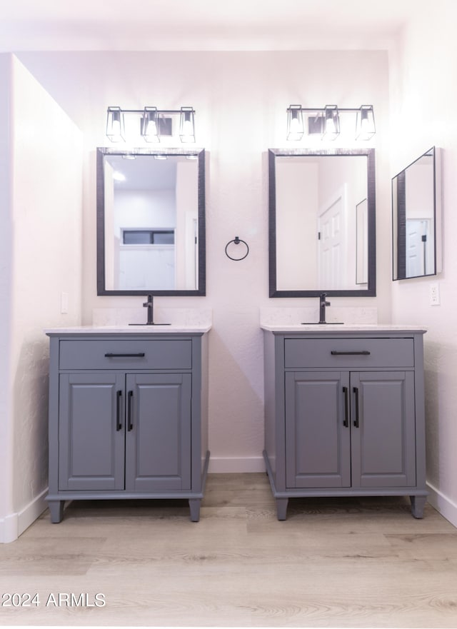 bathroom with vanity and hardwood / wood-style flooring