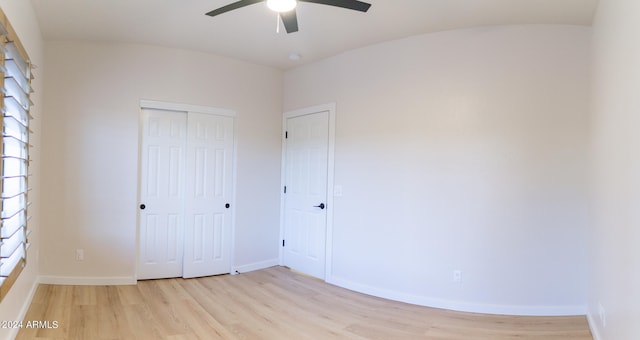 unfurnished bedroom featuring light hardwood / wood-style floors, multiple windows, a closet, and ceiling fan