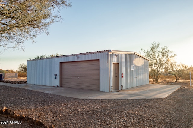 view of garage at dusk