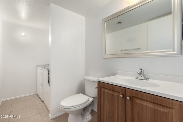 bathroom with toilet, vanity, and tile patterned flooring