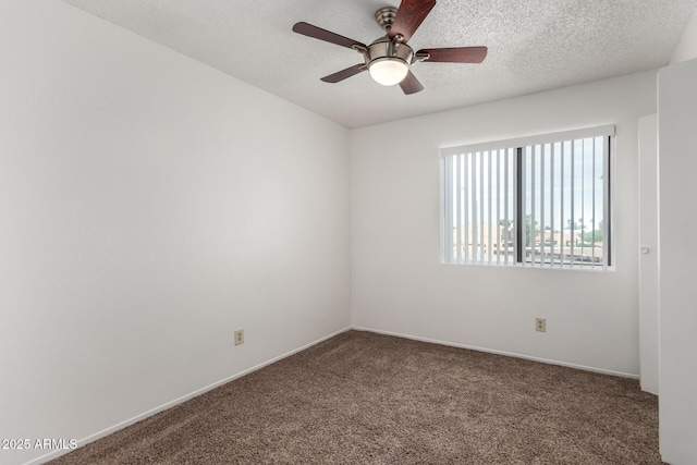 carpeted spare room with ceiling fan and a textured ceiling