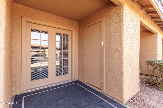 view of exterior entry featuring french doors