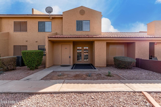 entrance to property featuring central air condition unit and french doors