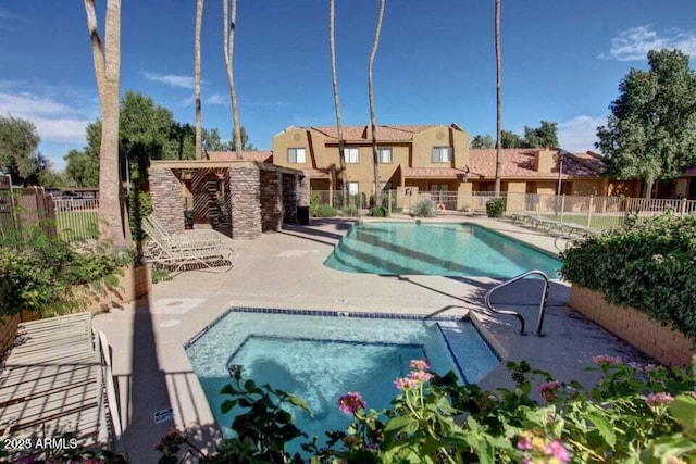 view of swimming pool with a patio area and a community hot tub