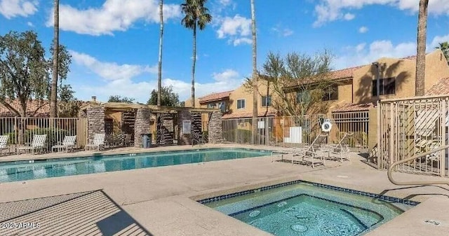 view of swimming pool with a patio area and a hot tub