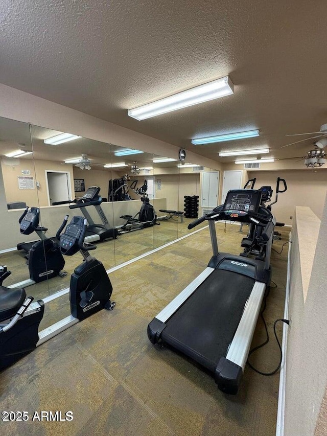 exercise room featuring a textured ceiling