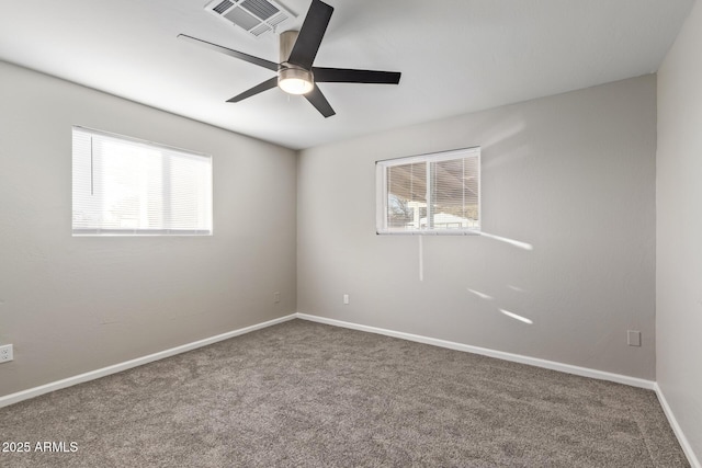 spare room featuring ceiling fan and carpet