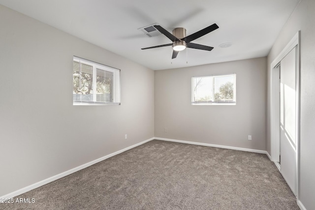 unfurnished room featuring carpet and ceiling fan