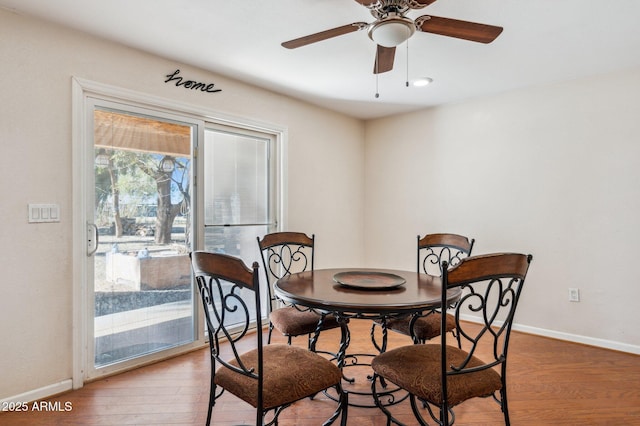 dining area featuring ceiling fan and wood-type flooring