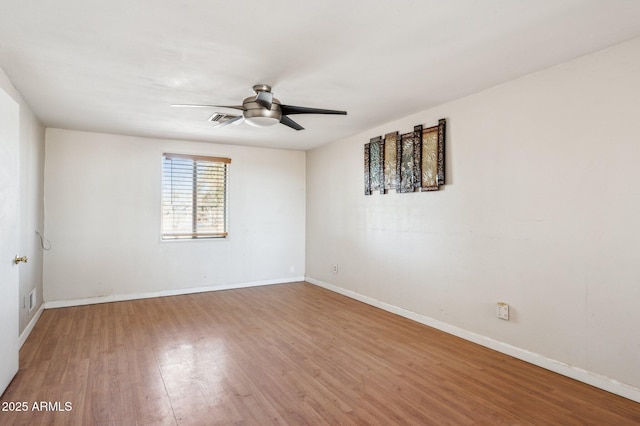 spare room featuring hardwood / wood-style floors and ceiling fan