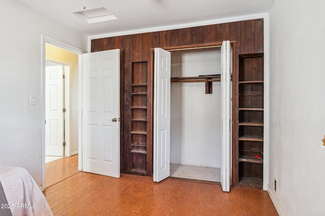 unfurnished bedroom with a closet and light wood-type flooring