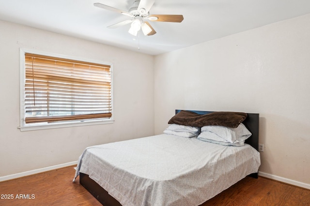 bedroom featuring dark hardwood / wood-style floors and ceiling fan