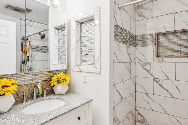 bathroom featuring tasteful backsplash, vanity, and curtained shower