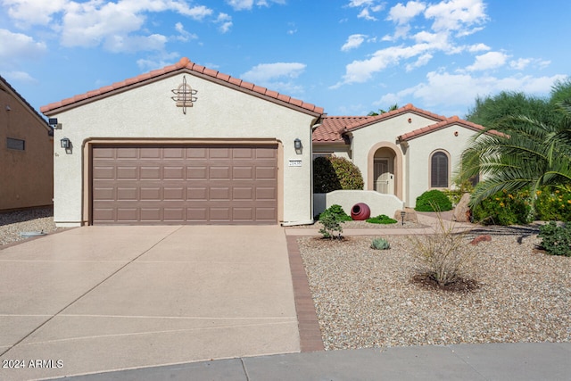 mediterranean / spanish-style house featuring a garage