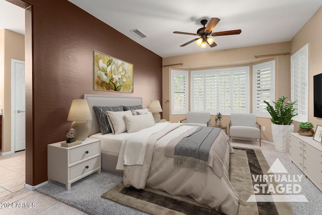 tiled bedroom featuring ceiling fan