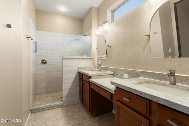 bathroom featuring tile patterned floors, vanity, and tiled shower