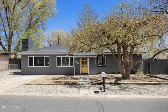 2808 N Steves Blvd, Flagstaff, AZ 86004 - ranch-style house featuring a chimney, fence, and a shingled roof