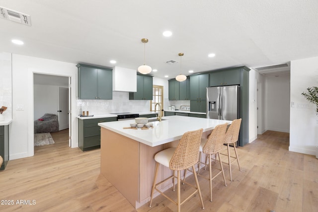 2808 N Steves Blvd, Flagstaff, AZ 86004 - kitchen with appliances with stainless steel finishes, visible vents, light countertops, and light wood finished floors