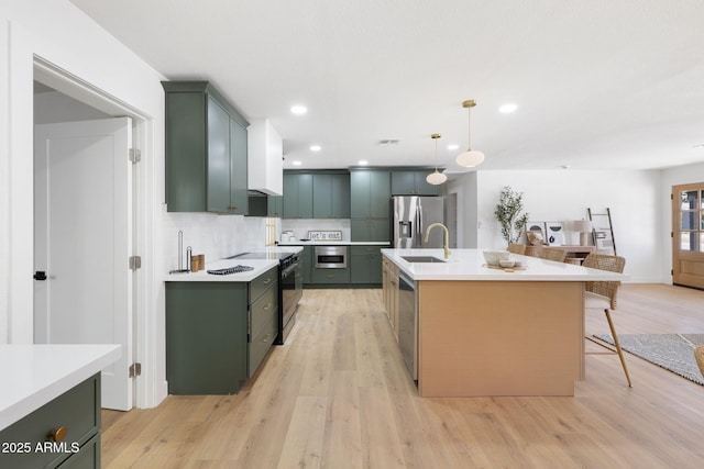 2808 N Steves Blvd, Flagstaff, AZ 86004 - kitchen featuring green cabinetry, stainless steel appliances, and light countertops