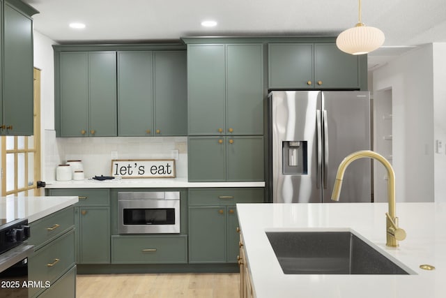 2808 N Steves Blvd, Flagstaff, AZ 86004 - kitchen featuring a sink, green cabinets, light countertops, pendant lighting, and stainless steel fridge with ice dispenser