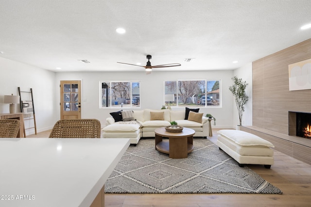2808 N Steves Blvd, Flagstaff, AZ 86004 - living area with a large fireplace, visible vents, recessed lighting, wood finished floors, and a ceiling fan