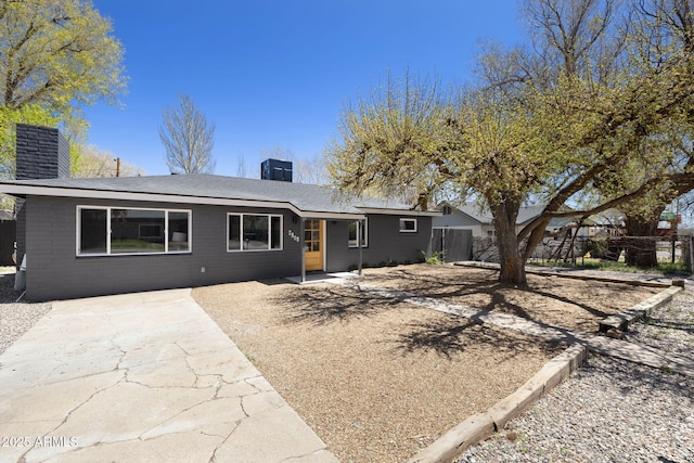 2808 N Steves Blvd, Flagstaff, AZ 86004 - view of front of house with fence, a chimney, and a patio area