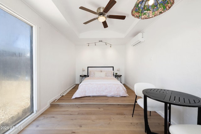 2808 N Steves Blvd, Flagstaff, AZ 86004 - bedroom with ceiling fan, light wood-type flooring, a wall unit AC, and multiple windows