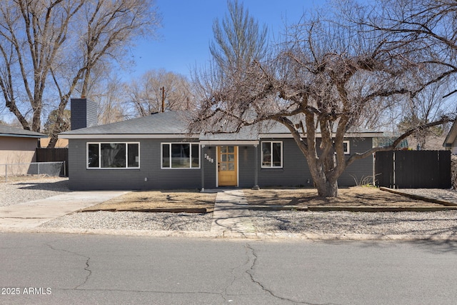 2808 N Steves Blvd, Flagstaff, AZ 86004 - view of front of home with a chimney and fence
