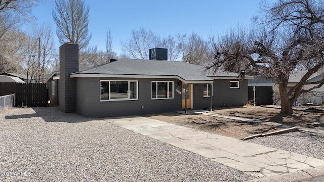 2808 N Steves Blvd, Flagstaff, AZ 86004 - rear view of house featuring a chimney and fence