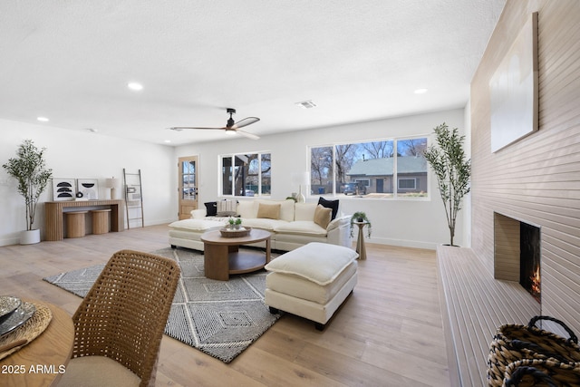 2808 N Steves Blvd, Flagstaff, AZ 86004 - living room with light wood-type flooring, recessed lighting, a brick fireplace, and baseboards