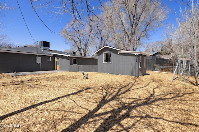 2808 N Steves Blvd, Flagstaff, AZ 86004 - rear view of property with fence, central air condition unit, and an outbuilding