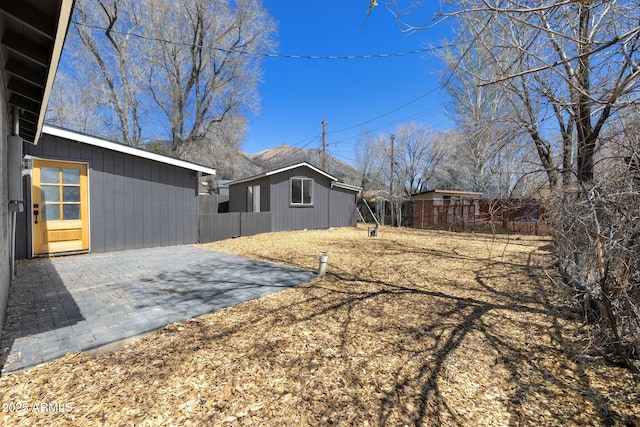 2808 N Steves Blvd, Flagstaff, AZ 86004 - view of yard featuring a patio area, an outbuilding, and a fenced backyard
