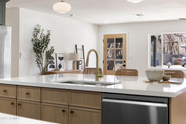 2808 N Steves Blvd, Flagstaff, AZ 86004 - kitchen with a sink, light countertops, visible vents, pendant lighting, and stainless steel dishwasher