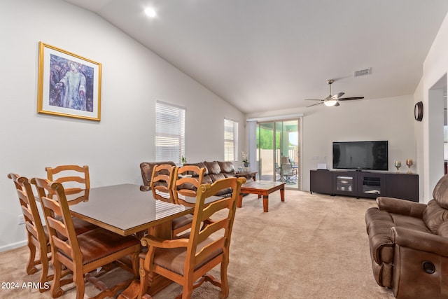 carpeted dining area with lofted ceiling and ceiling fan