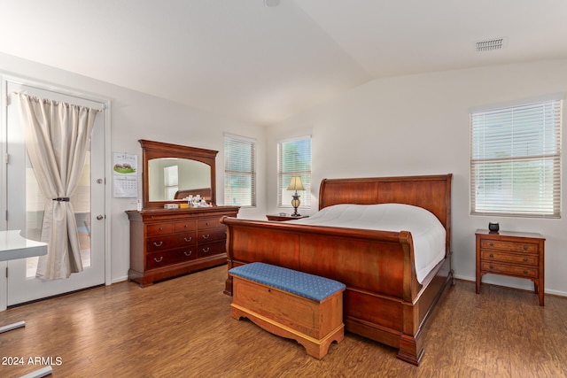 bedroom featuring lofted ceiling and hardwood / wood-style floors