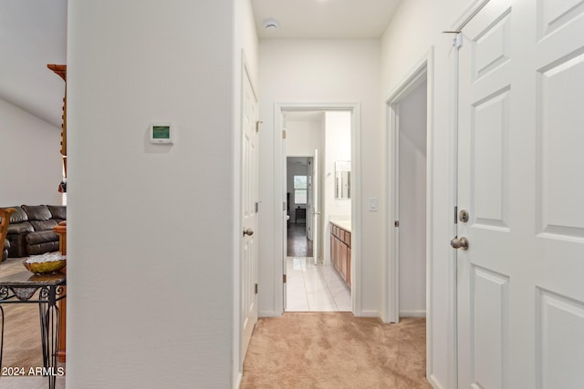 hallway featuring light carpet